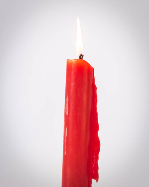 istock Filtered image studio shot one burning Asian red candle isolated on white 1181389484