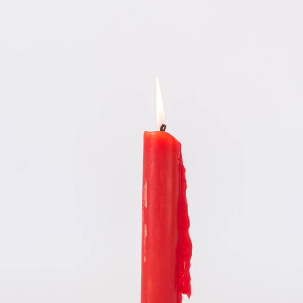 istock Studio shot one burning Asian red candle isolated on white 1181389498