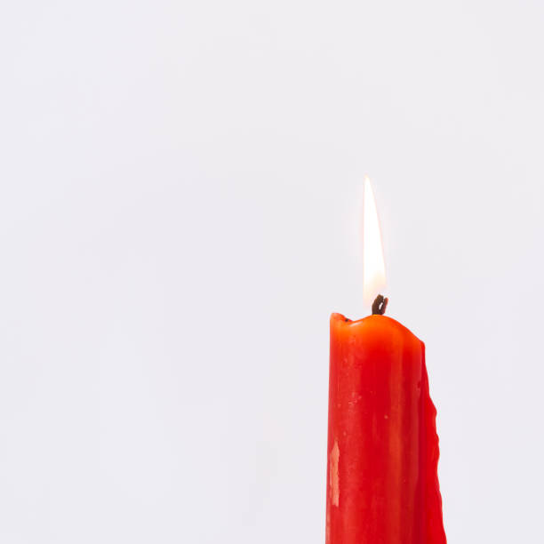 istock Studio shot one burning Asian red candle isolated on white 1181389504