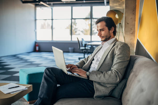 istock Businessman in modern office working on laptop 1181391312