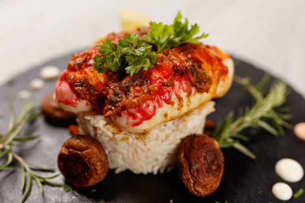 code di aragosta servite su piatto di granito - lobster steak lobster tail main course foto e immagini stock