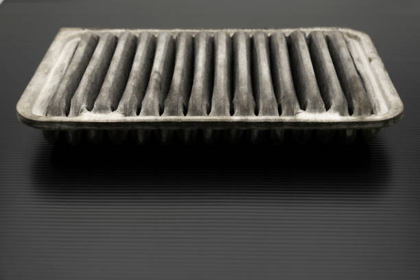 istock Old dirty automotive engine air filter isolated on black background 1181392311
