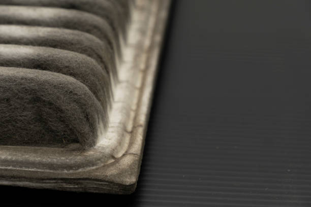 istock Old dirty automotive engine air filter isolated on black background 1181392353