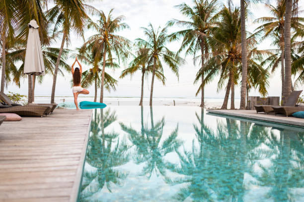 istock Tree pose and palm trees on tropical island paradise 1181392475