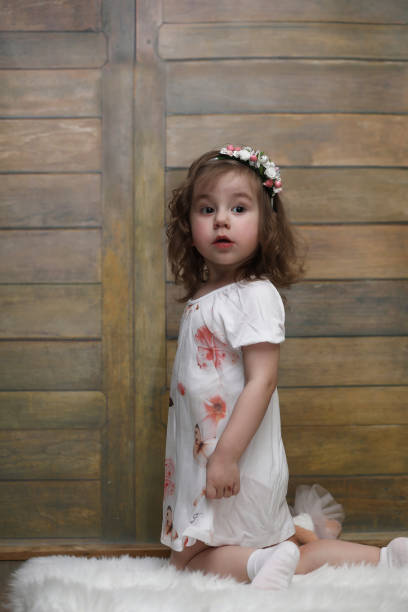 istock Little girl with curly hair, having fun while posing 1181394170