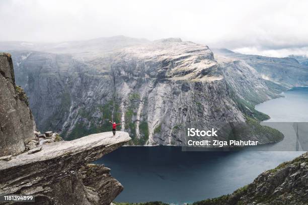 Woman Standing On Trolltunga Stock Photo - Download Image Now - Trolltunga, Norway, Fjord