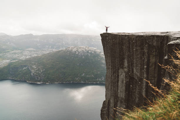 istock Man standing on Pulpit rock, Preikestolen - Norway 1181394905