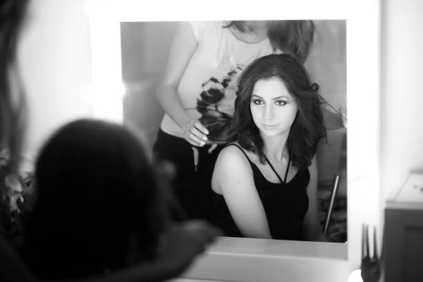 istock Girl doing makeup black and white 1181395259