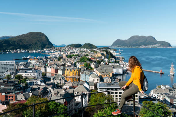Woman tourist at viewpoint on top of mount Aksla - Alesund, Norway stock photo