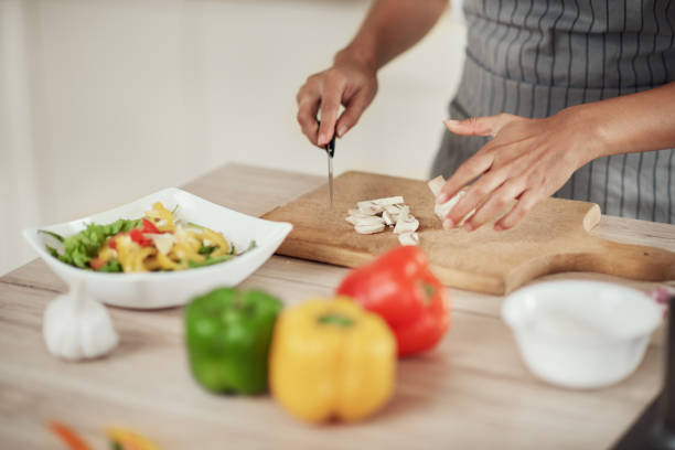 istock Woman chopping mushrooms. 1181395565