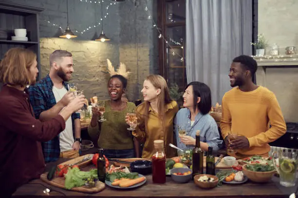 Photo of Diverse Group of Young People Enjoying Dinner Party