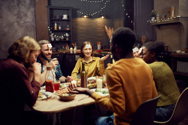 istock Group of Friends Playing Guessing Game at Dinner 1181395765