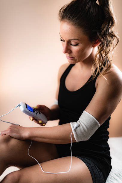 istock Elbow Physical Therapy with TENS Electrode Brace Pads, Transcutaneous Electrical Nerve Stimulation 1181396931