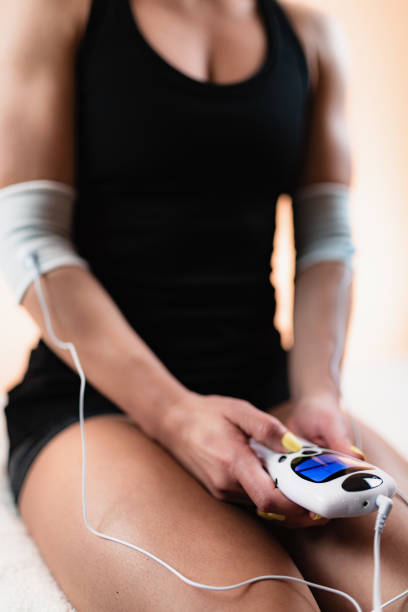 istock Elbow Physical Therapy with TENS Electrode Brace Pads, Transcutaneous Electrical Nerve Stimulation 1181398096
