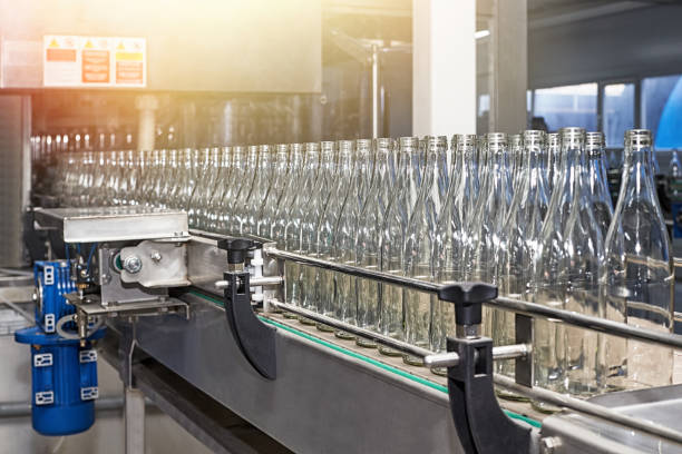 Automated conveyor for bottling water in glass bottles stock photo