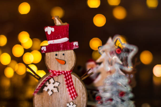 istock Christmas decorations against blurred background. Small wooden snowman. 1181402011