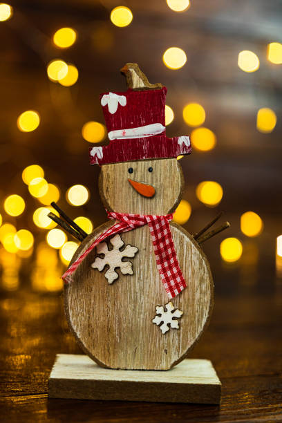 istock Christmas decorations against blurred background. Small wooden snowman. 1181402046