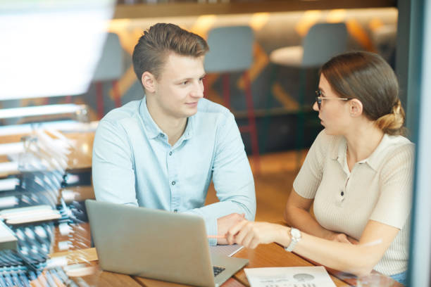 istock Shocked young businesswoman pointing at laptop screen while offering development strategy to colleague at meeting in cafe 1181402093