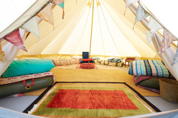 Interior View Of Teepee Tent Pitched On Glamping Camp Site With No People Interior View Of Teepee Tent Pitched On Glamping Camp Site With No People glamping photos stock pictures, royalty-free photos & images