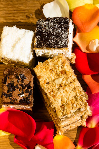 istock Diversity of mini cakes on a wooden board. 1181405421
