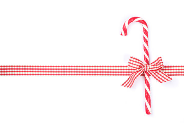 istock Sweet candy cane with bow isolated on white background 1181407020