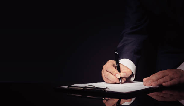 istock Lawyer, notary, attorney signs document 1181407070