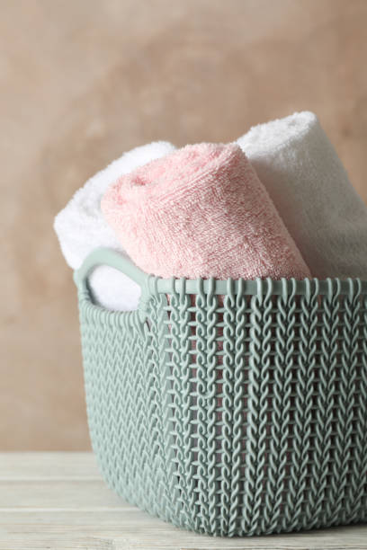 istock Basket with clean laundry on wooden board, space for text 1181408611