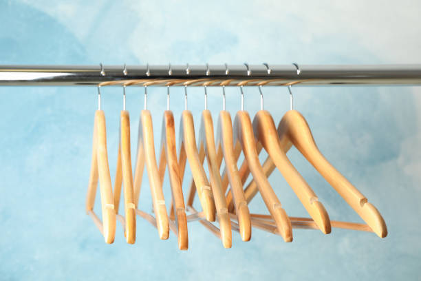 istock Hangers on rod against blue background, space for text 1181408663