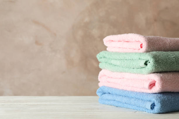 istock Stack of clean towels against brown background, space for text 1181408706