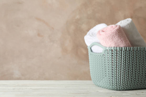 istock Basket with clean laundry on wooden board, space for text 1181409359