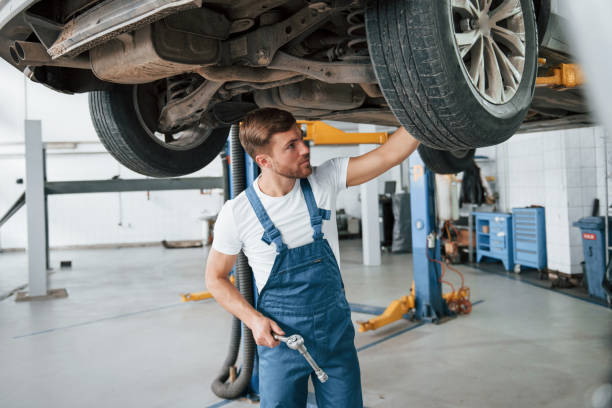 istock Unusual problem. Employee in the blue colored uniform works in the automobile salon 1181409876