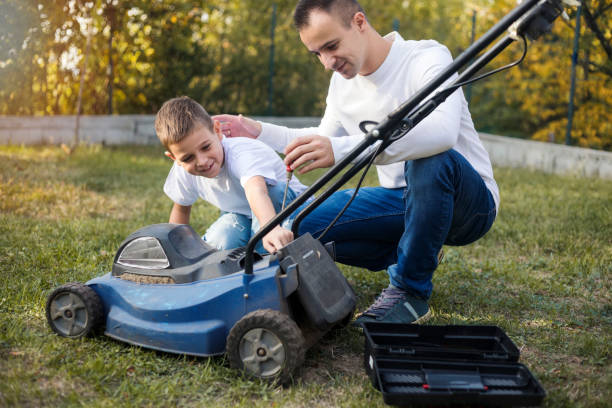 istock Father and son working together in formal garden 1181410801