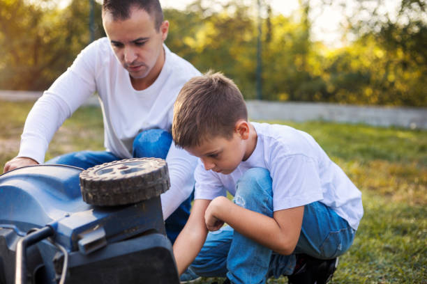 istock Father and son working together in formal garden 1181411106