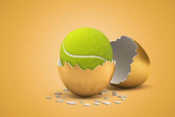 3d rendering of tennis ball hatching out of golden egg on yellow background stock photo