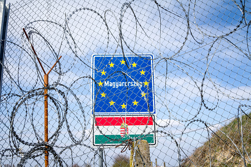 Picture of an European Union Entrance sign, on a road obstreucted by the Hungarian border fence.  It was built during the refugees crisis to stop the refugees from taking the Balkans Route