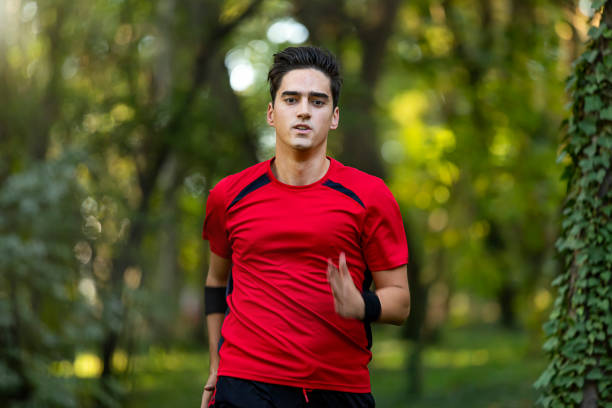 istock Athlete running in the forest 1181412689