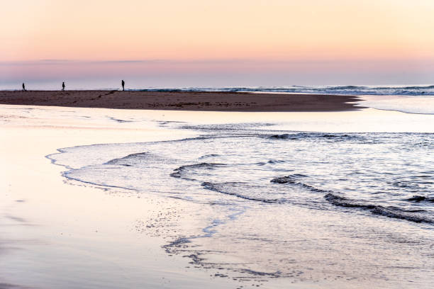 istock Silhouettes in sunset or sunrise at the beach 1181413034