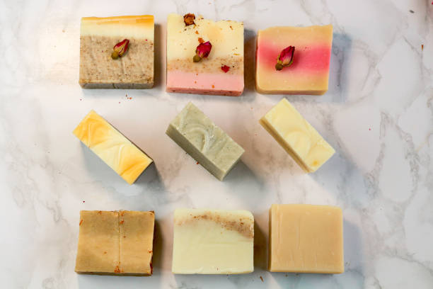 istock Handmade multicolored soap with honey. lavender, mint, herbs and rosebuds on a marble background with a space for text. Spa soap for face and body treatments flat lay style 1181413862