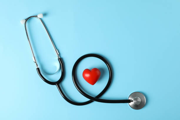 istock Stethoscope and heart on blue background, top view 1181414556