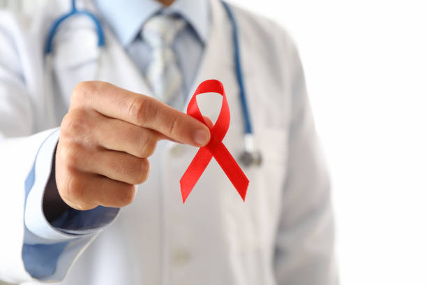 istock Doctor holds a red ribbon, close up and space for text 1181415217