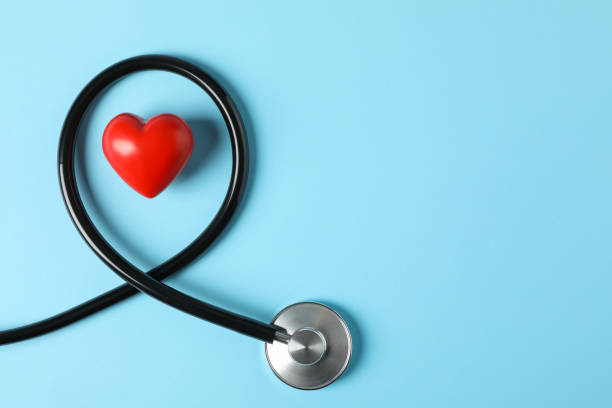 istock Stethoscope and heart on blue background, top view 1181415785