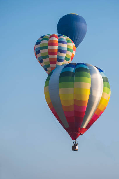 istock Multicolored balloon flying in the clean blue sky. 1181415985