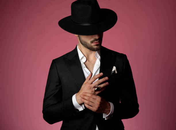 istock Curious man looking away and playing with his hands 1181416349