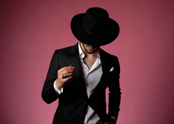 istock Thoughtful man rubbing his fingers while wearing a black suit 1181417068