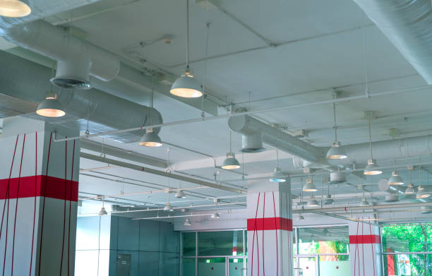 istock Air duct, air conditioner pipe, fire sprinkler system. Air flow and ventilation system. Building interior. Ceiling lamp light with opened light. Interior architecture. Glass wall building. 1181417644
