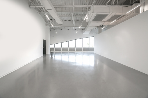 White walls and grey cement floors in the interior space