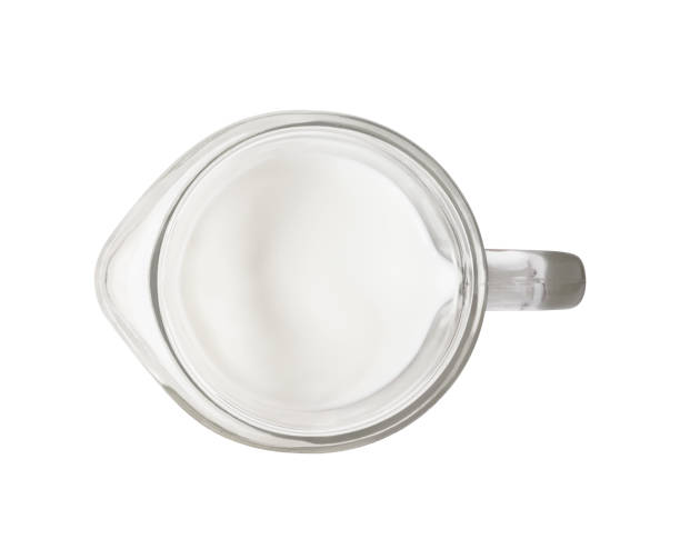 Top view of milk in glass jar Top view of milk in glass jar isolated on white background jar of milk stock pictures, royalty-free photos & images