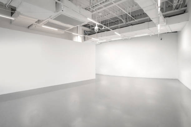 White walls and grey cement floors in the interior space