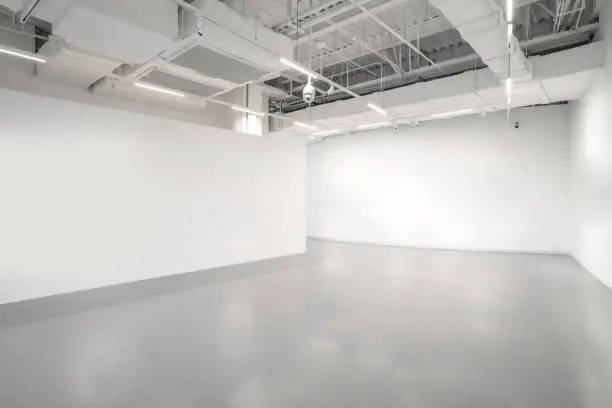Photo of White walls and grey cement floors in the interior space