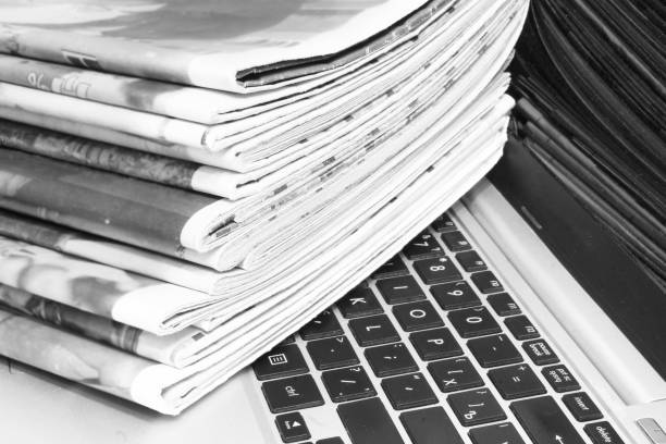 istock Newspapers and Laptop 1181423560